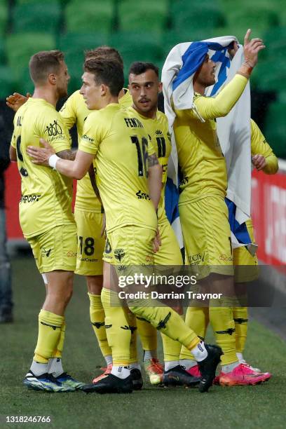 Tomer Hemed of the Phoenix wraps himself in the flag of Israel to celebrate a goal from a penalty during the A-League match between Melbourne City...