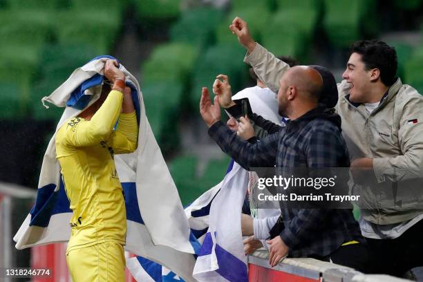Tomer Hemed of the Phoenix wraps himself in the flag of Israel to celebrate a goal from a penalty during the A-League match between Melbourne City...