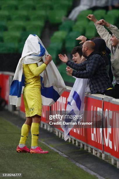 Tomer Hemed of the Phoenix wraps himself in the flag of Israel to celebrate a goal from a penalty during the A-League match between Melbourne City...