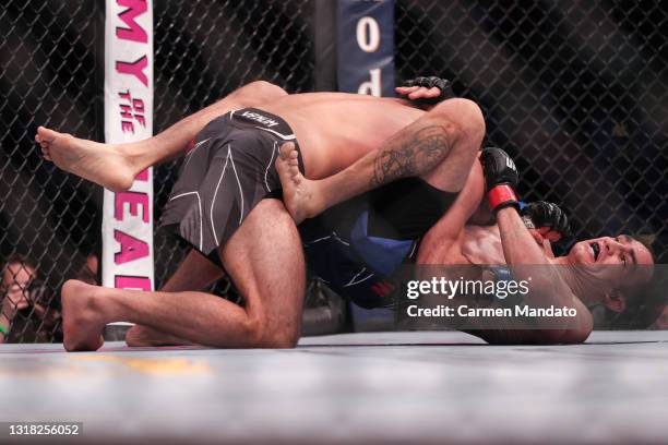 Tony Ferguson and Beneil Dariush of Iran wrestle during their Lightweight Bout at the UFC 262 event at Toyota Center on May 15, 2021 in Houston,...