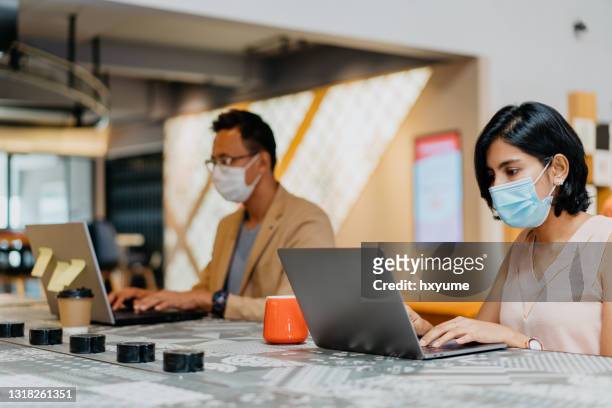 social distancing and wear a face mask in work place - social distancing stock pictures, royalty-free photos & images