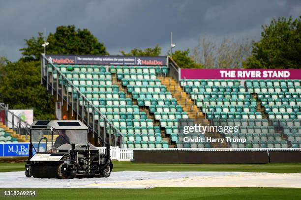 Groundstaff work on the covers as heavy rain on the outfield delays the start of play during Day Four of the LV= Insurance County Championship match...