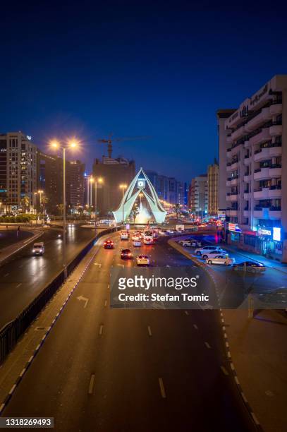deira clock tower roundabout in old dubai area at blue hour - deira stock pictures, royalty-free photos & images