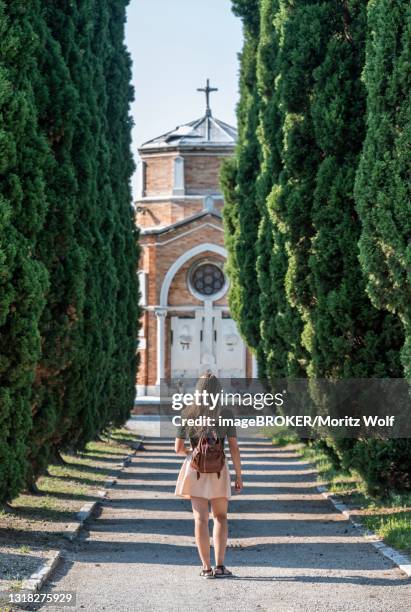 young woman on the main path of the cemetery island san michele, venice, italy - abby road stock-fotos und bilder