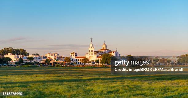 village el rocio with hermitage of el rocio, hermitage ermita del rocio in the evening light, el rocio, almonte, province huelva, andalusia, spain - provincia de huelva stock pictures, royalty-free photos & images