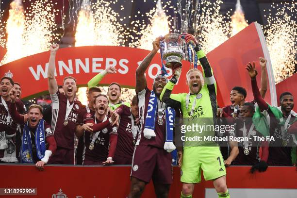 Kasper Schmeichel and Wes Morgan of Leicester City lift the Emirates FA Cup Trophy in celebration with team mates following The Emirates FA Cup Final...