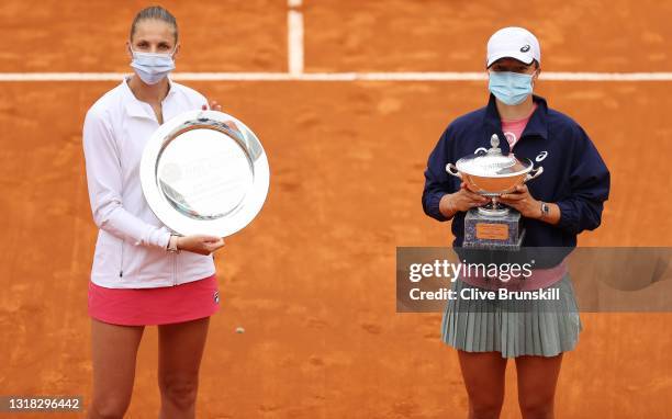 Karolina Pliskova of the Czech Republic poses with the runners up plate and Iga Swiatek of Poland poses with the winners trophy after the women's...