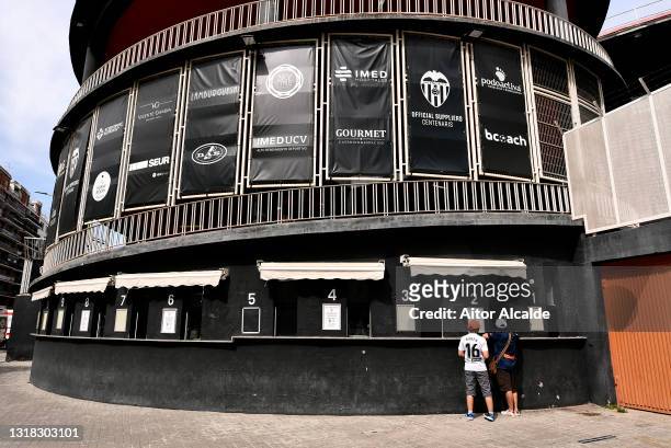 Fans collect their tickets at the ticket office outside the stadium prior to the La Liga Santander match between Valencia CF and SD Eibar at Estadio...