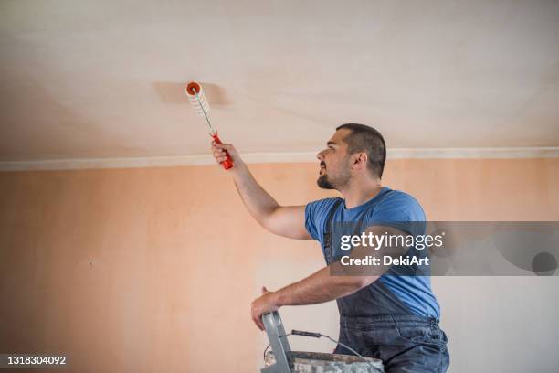 middle age worker doing his paint job - painted ceiling stock pictures, royalty-free photos & images