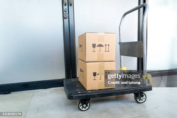 hand truck loaded with boxes isolated - cartgate out stock pictures, royalty-free photos & images