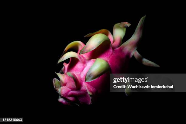 dragon fruit on black background - dragon fruit fotografías e imágenes de stock