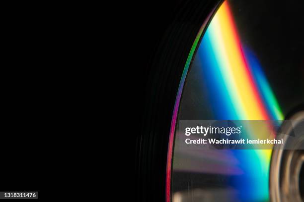 cds on black background - colorful cd photos et images de collection