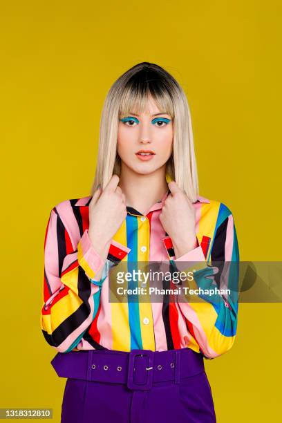 fashionable young woman in colorful outfit - multi colored shirt foto e immagini stock