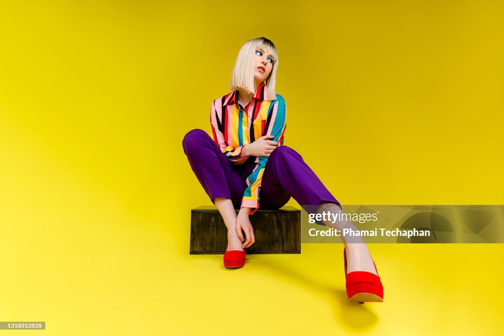 Fashionable young woman in colorful outfit