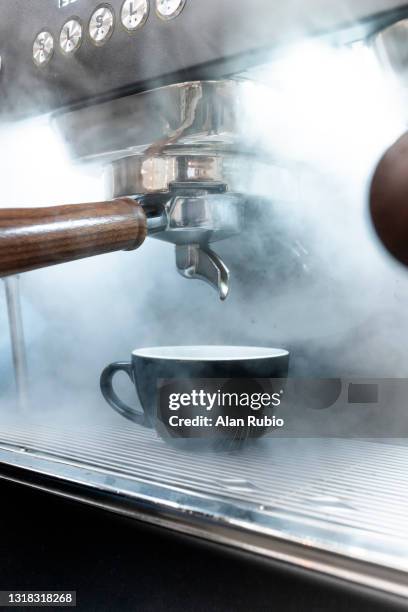 barista preparing a coffee while smoke comes out when heating the milk. - breakfast top view stock pictures, royalty-free photos & images