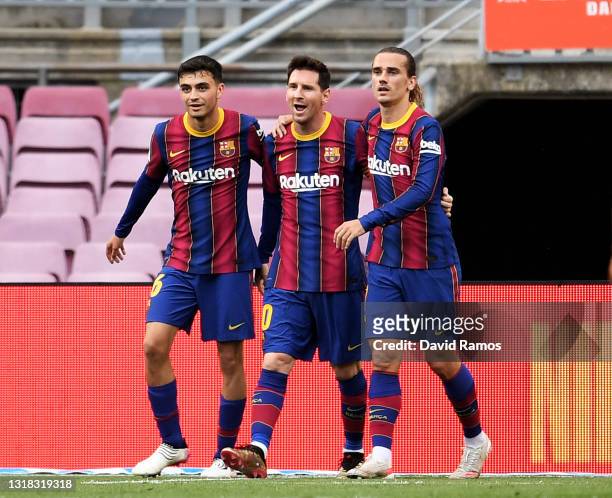 Lionel Messi of FC Barcelona celebrates after scoring their team's first goal with Antoine Griezmann and Pedri during the La Liga Santander match...