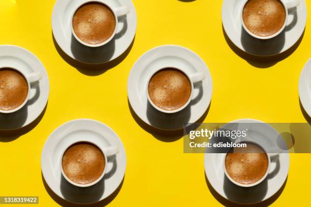 pattern made of cup of cappuccino on yellow background - coffe print stock pictures, royalty-free photos & images