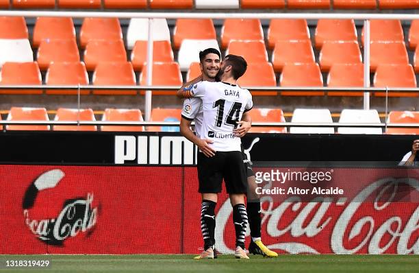 Carlos Soler of Valencia CF celebrates with team mate Jose Gaya after scoring their side's third goal during the La Liga Santander match between...
