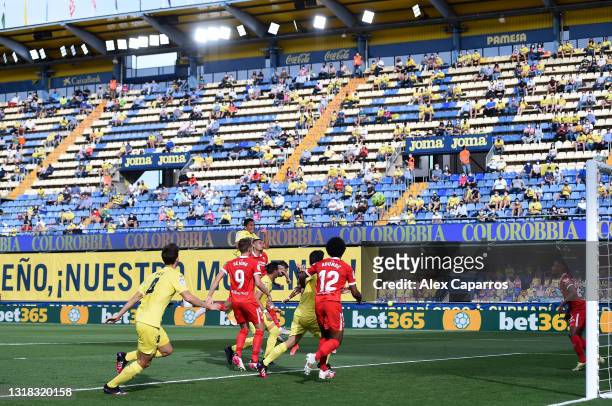 Carlos Bacca of Villarreal CF scores their side's first goal as fans can be seen social distancing in the stand during the La Liga Santander match...