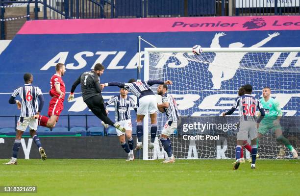 Alisson of Liverpool scores their side's second goal past Sam Johnstone of West Bromwich Albion during the Premier League match between West Bromwich...