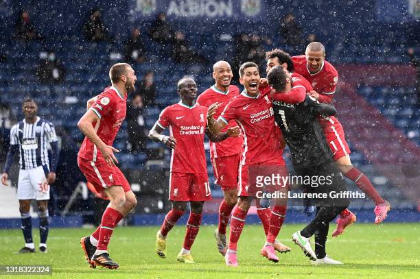 Alisson of Liverpool celebrates with team mates Sadio Mane, Fabinho, Roberto Firmino, Mohamed Salah and Thiago after scoring their side's second goal...