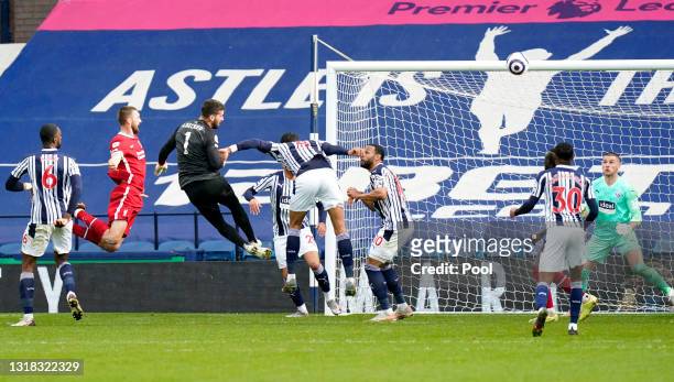 Alisson of Liverpool scores their side's second goal past Sam Johnstone of West Bromwich Albion during the Premier League match between West Bromwich...
