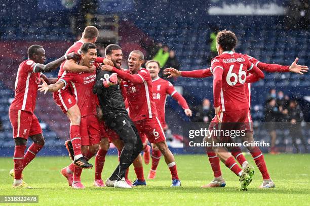 Alisson of Liverpool celebrates with Roberto Firmino, Thiago and team mates after scoring their side's second goal during the Premier League match...