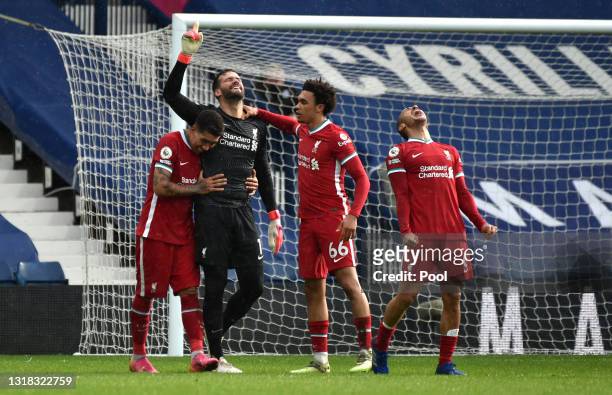 Alisson of Liverpool celebrates with team mates Roberto Firmino, Trent Alexander-Arnold and Thiago after scoring their side's second goal during the...