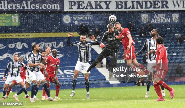 Alisson Becker of Liverpool Heads home the winner during the Premier League match between West Bromwich Albion and Liverpool at The Hawthorns on May...