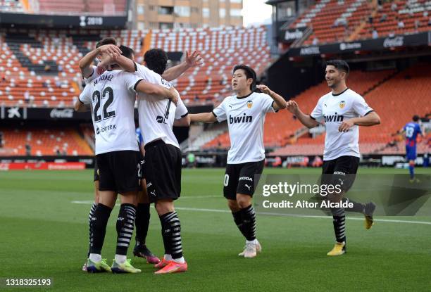 Goncalo Guedes of Valencia CF celebrates with team mates after scoring their side's fourth goal during the La Liga Santander match between Valencia...