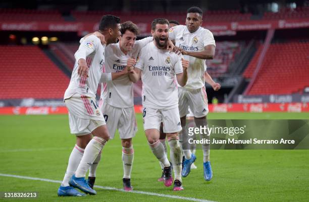 Nacho of Real Madrid celebrates with team mates after scoring their side's first goal during the La Liga Santander match between Athletic Club and...