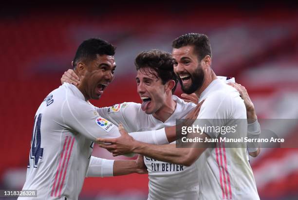 Nacho of Real Madrid celebrates with team mates Casemiro and Alvaro Odriozola after scoring their side's first goal during the La Liga Santander...
