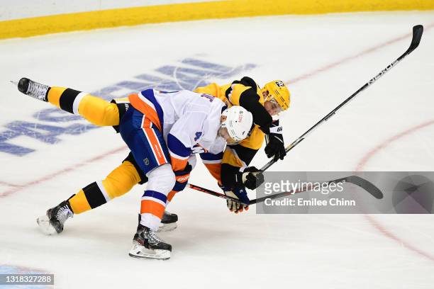 Andy Greene of the New York Islanders is called for interference against Jeff Carter of the Pittsburgh Penguins during the second period in Game One...