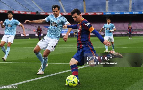 Lionel Messi of FC Barcelona crossing the ball past Augusto Solari of Celta Vigo during the La Liga Santander match between FC Barcelona and RC Celta...