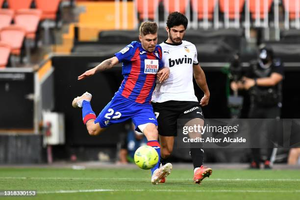 Goncalo Guedes of Valencia CF battles for possession with Alejandro Pozo of SD Eibar during the La Liga Santander match between Valencia CF and SD...