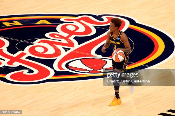 Danielle Robinson of the Indiana Fever brings the ball up the court in the game against the New York Liberty at Bankers Life Fieldhouse on May 16,...