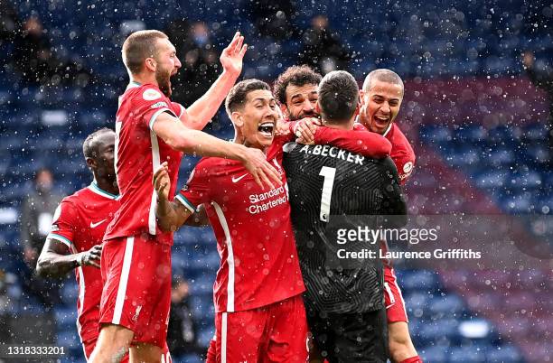 Alisson of Liverpool celebrates with team mates Nathaniel Phillips, Roberto Firmino, Mohamed Salah and Thiago after scoring their side's second goal...