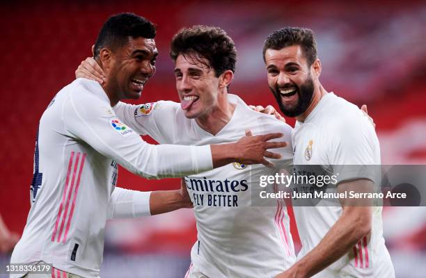 Nacho Fernandez of Real Madrid celebrates with his teammate Carlos Casemiro and Alvaro Odriozola of Real Madrid after scoring the opening goal during...