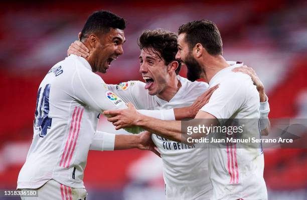 Nacho Fernandez of Real Madrid celebrates with his teammate Carlos Casemiro and Alvaro Odriozola of Real Madrid after scoring the opening goal during...
