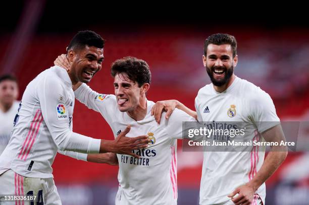 Nacho Fernandez of Real Madrid celebrates with his teammate Carlos Casemiro and Alvaro Odriozola of Real Madrid after scoring the opening goal during...