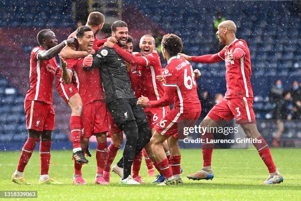 Alisson Becker of Liverpool is congratulated by Sadio Mane, Roberto Firmino, Thiago Alcantara, Trent Alexander-Arnold and Fabinho after scoring the...