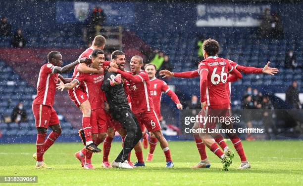 Alisson Becker of Liverpool is congratulated by Sadio Mane, Roberto Firmino, Thiago Alcantara, Trent Alexander-Arnold and Fabinho after scoring the...