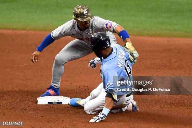 Manuel Margot of the Tampa Bay Rays is tagged out by Francisco Lindor of the New York Mets on an rbi single and attempted double during the eighth...