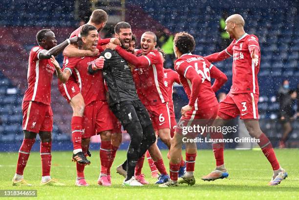 Alisson Becker of Liverpool is congratulated by Sadio Mane, Roberto Firmino, Thiago Alcantara, Trent Alexander-Arnold and Fabinho after scoring the...