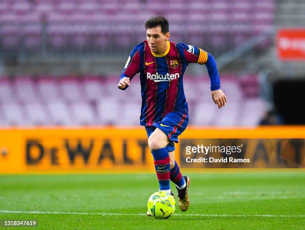 Lionel Messi of FC Barcelona runs with the ball during the La Liga Santander match between FC Barcelona and RC Celta at Camp Nou on May 16, 2021 in...