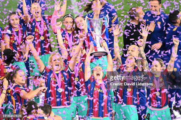 Alexia Putellas of FC Barcelona lifts the UEFA Women's Champions League Trophy in celebration with team mates following the UEFA Women's Champions...