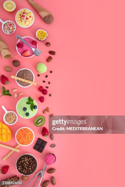 assorted ice cream cups in a row and waffle cones colorful on pink background - mint chocolate chip ice cream scoop stock pictures, royalty-free photos & images