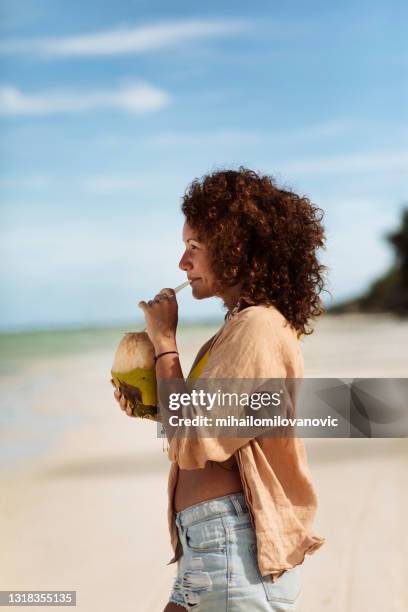 she needed some beach time - coconut water stock pictures, royalty-free photos & images