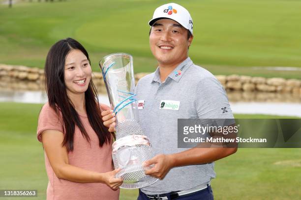 Lee of South Korea and his wife celebrate with the trophy after winning the AT&T Byron Nelson at TPC Craig Ranch on May 16, 2021 in McKinney, Texas....
