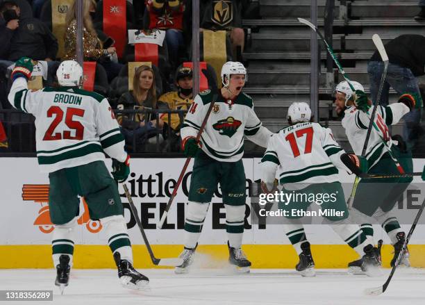 Jonas Brodin, Joel Eriksson Ek, Marcus Foligno and Jordan Greenway of the Minnesota Wild celebrate after Eriksson Ek scored an overtime goal against...